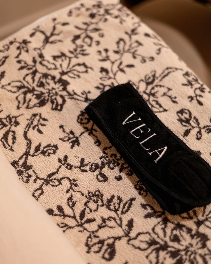 A VELA headband laid out on the treatment bed